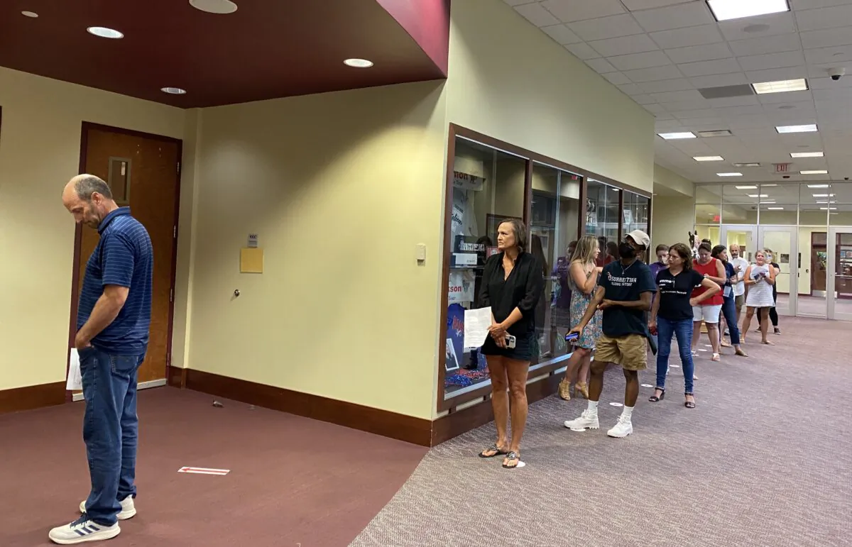 Speakers waited in a group of ten outside the board room while other speakers waited outdoors or in their cars during the Loudoun County Public School Board meeting, Va., on Aug. 10, 2021. (Terri Wu/The Epoch Times)