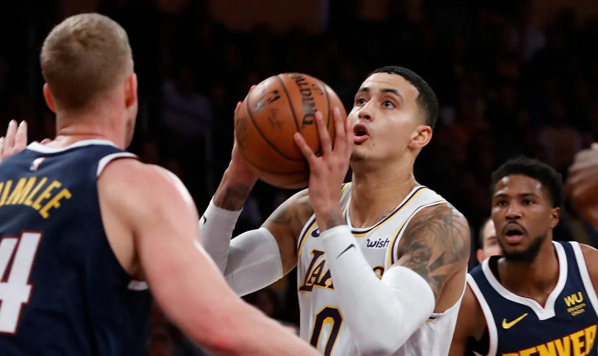 The Los Angeles Lakers' Kyle Kuzma goes to the basket against the Denver Nuggets' Mason Plumlee, left, at Staples Center in Los Angeles on Dec. 22, 2019. (Luis Sinco/Los Angeles Times/TNS)