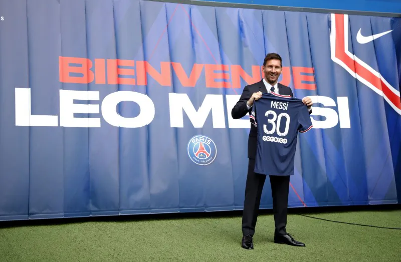 Lionel Messi Press Conference after signing for Paris St Germain. Paris St Germain's Lionel Messi poses with a shirt on the pitch after the press conference in Parc des Princes, Paris, France, on Aug. 11, 2021. (Sarah Meyssonnier/Reuters)