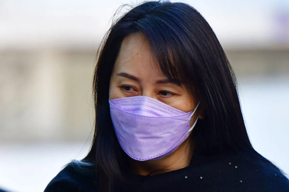 Huawei Chief Financial Officer, Meng Wanzhou (C) arrives at the British Columbia Supreme Court with her security detail in Vancouver, British Colombia on March 22, 2021. (Don Mackinnon/AFP via Getty Images)