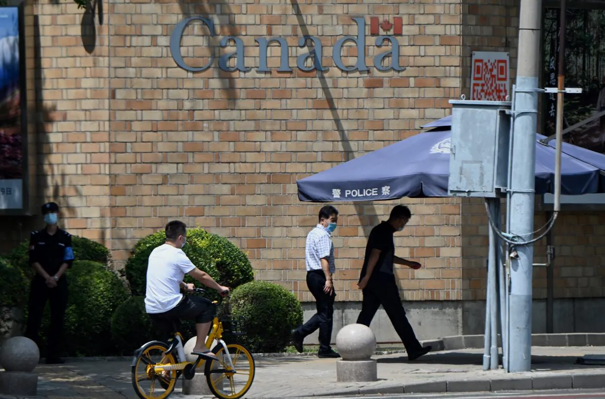 People walk past the Canadian Embassy as a Chinese court upheld the death sentence passed on Canadian citizen Robert Lloyd Schellenberg for drug smuggling in Beijing on Aug. 10, 2021. (Noel Celis/AFP via Getty Images)