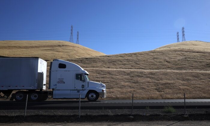 A truck drives by hills covered in dry grass along Highway 5 in Los Banos, Calif. on May 25, 2021. (Justin Sullivan/Getty Images)