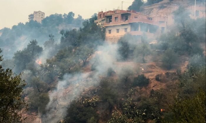On August 10, 2021, smoke was emitted from a wildfire in Tizi Ouzou, a mountainous region east of Algiers, the capital of Algeria.  (AbdelazizBoumzar / Reuters)
