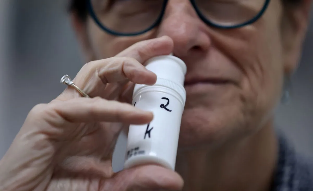 A technician displays a sample of an anti-viral nose spray on April 7, 2021. (Emmanuel Dunand/AFP via Getty Images)
