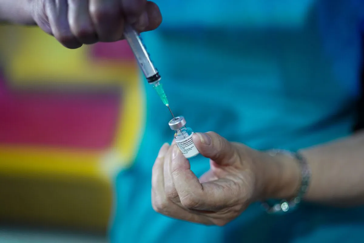 A doctor prepares the Pfizer-BioNTech COVID-19 vaccine at a vaccination center in Halifax, England, on July 31, 2021. (Ian Forsyth/Getty Images)