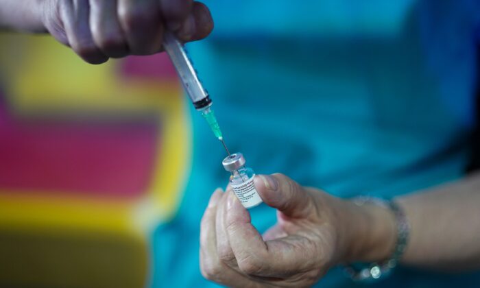 A doctor prepares the Pfizer-BioNTech COVID-19 vaccine at a vaccination center in Halifax, England, on July 31, 2021. (Ian Forsyth/Getty Images)