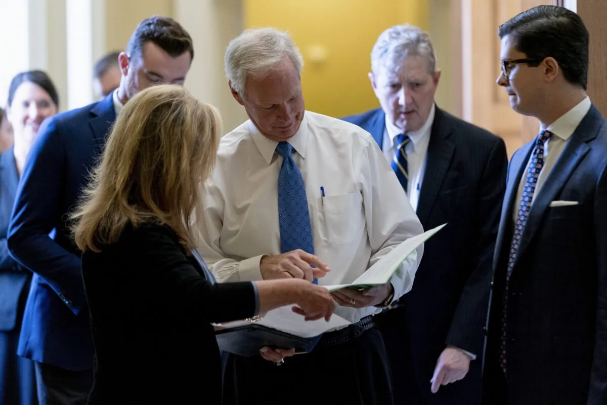 (L–R) Sen. Marsha Blackburn (R-Tenn.), Sen. Ron Johnson (R-Wis.), and Sen. John Kennedy (R-La.), leave a Republican policy luncheon as the Senate moves from passage of the infrastructure bill to focus on a massive $3.5 trillion budget resolution, a blueprint of President Joe Biden's top domestic policy ambitions, at the U.S. Capitol in Washington on Aug. 10, 2021. (Andrew Harnik/AP Photo)