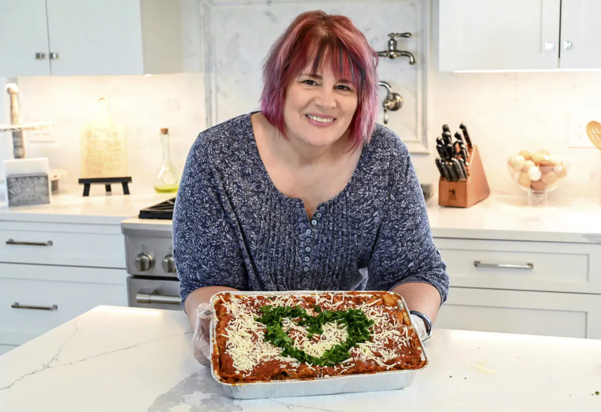 Shari DiBrito, the New Jersey regional director for the nonprofit Lasagna Love, holds a lasagna on May 1, 2021, at her niece's house in Wayne, N.J. The grassroots nonprofit organization offering Americans free lasagnas recently surpassed its 100,000 lasagna delivery mark. (Jason Adam Photography via AP)