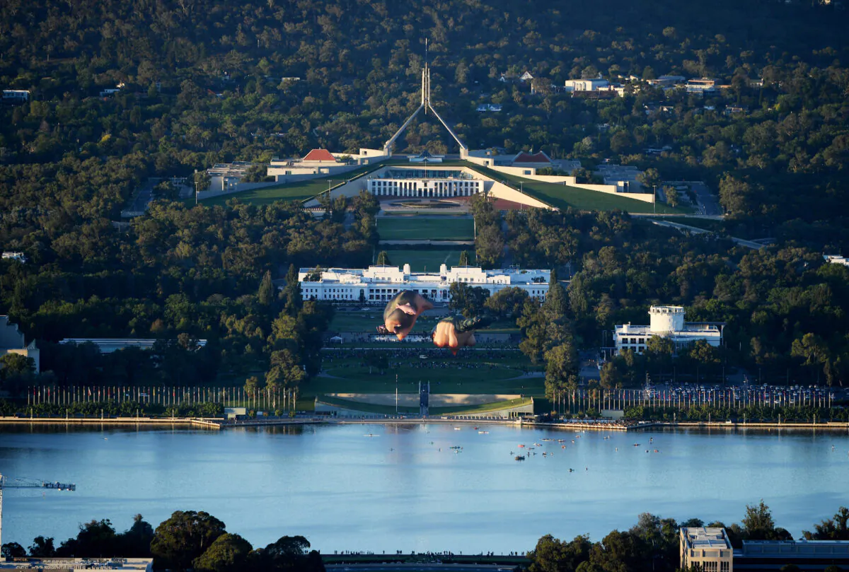 Crowds watch as Skywhalepapa is inflated in front of the Australian Parliament House next to the original Skywhale on February 07, 2021 in Canberra, Australia. (Tracey Nearmy/Getty Images)