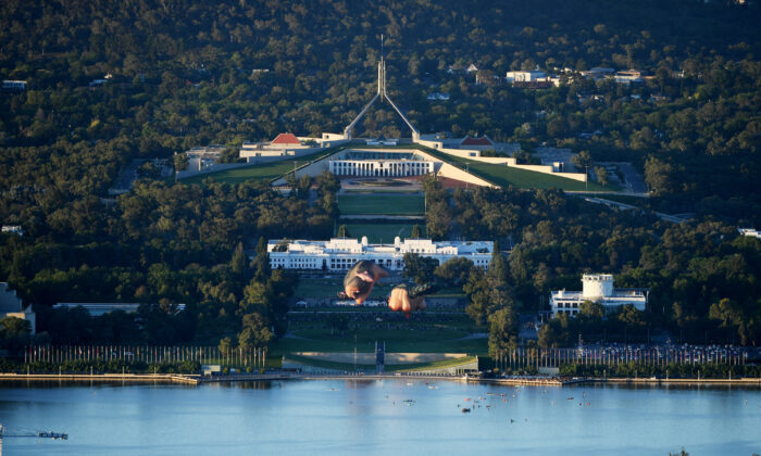 Crowds watch as Skywhalepapa is inflated in front of the Australian Parliament House next to the original Skywhale on February 07, 2021 in Canberra, Australia. (Tracey Nearmy/Getty Images)