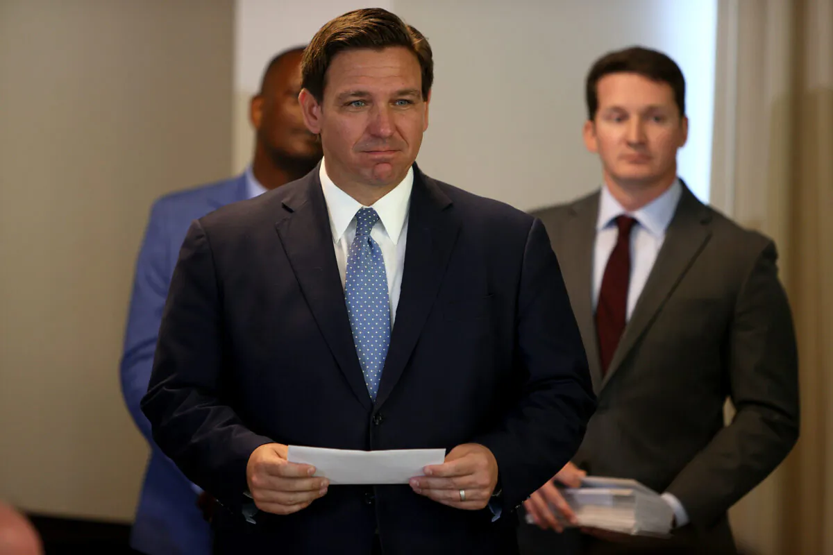 Florida Gov. Ron DeSantis waits to present a check to a first responder during an event to give out bonuses to them held at the Grand Beach Hotel Surfside in Surfside, Florida, on Aug. 10, 2021. (Joe Raedle/Getty Images)
