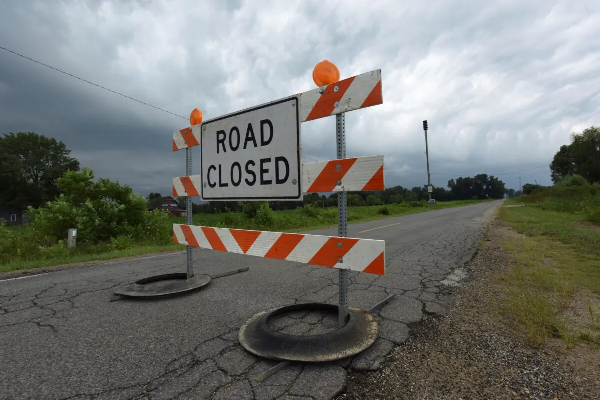 Recent heavy rains have closed area roads in Southwest Michigan including Holden Road at Shawnee Road in Bridgman, Mich., on Aug. 11, 2021. (Don Campbell/The Herald-Palladium via AP)

