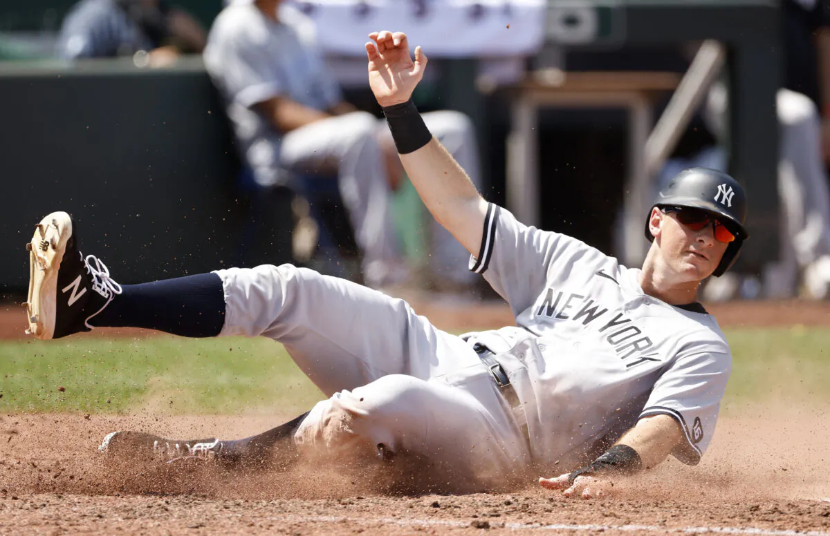 New York Yankees' DJ LeMahieu scores off an Aaron Judge single in the fourth inning of a baseball game against the Kansas City Royals at Kauffman Stadium in Kansas City, Mo., on Aug. 11, 2021. (Colin E. Braley/AP Photo)