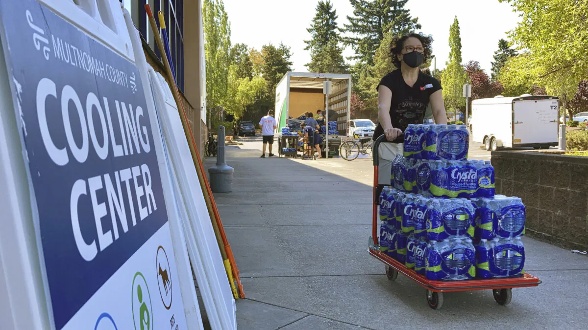 December Snedecor, a homeless woman who lives in a tent, helps set up snacks at a cooling center in Portland, Ore., on Aug. 11, 2021. (Gillian Flaccus/AP Photo)