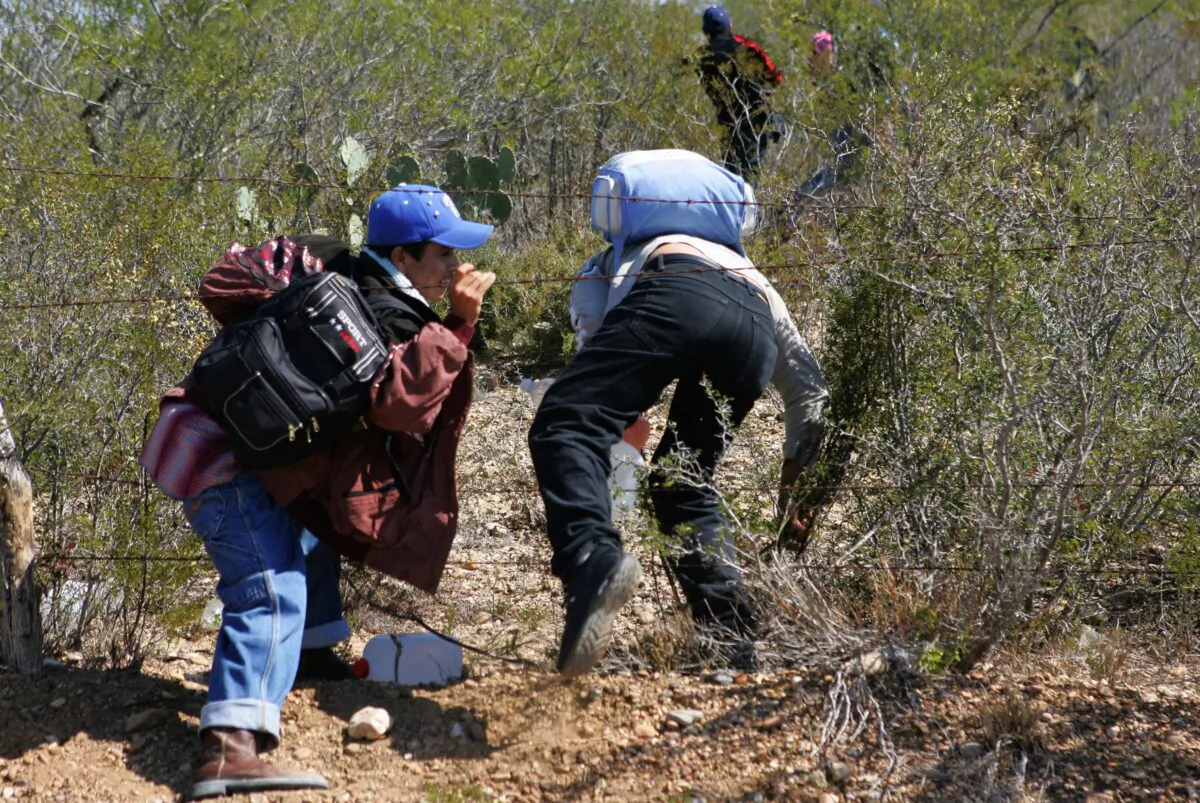 A group crosses a road on the way to Nuevo Laredo, Mexico, with the intention of entering the United States, in a file photograph. (Omar Torres/AFP via Getty Images)