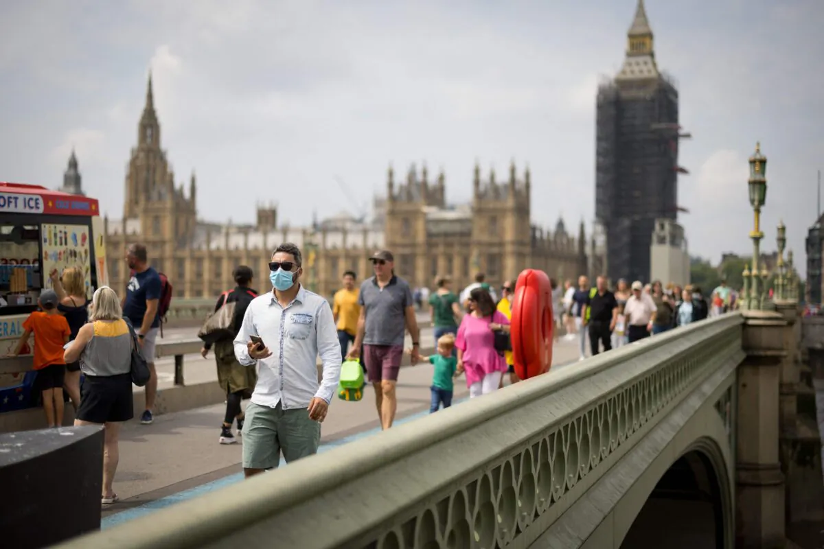 Pedestrians, cross Westminster Bridge in central London on July 26, 2021. (Tolga Akmen / AFP via Getty Images)