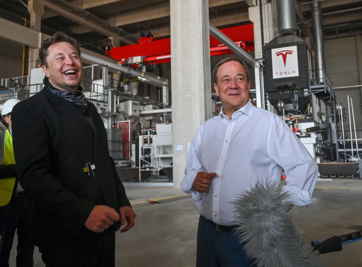 Tesla CEO Elon Musk and Christian Democratic Union (CDU) party leader Armin Laschet visit the construction site of Tesla's Gigafactory in Gruenheide near Berlin, Aug. 13, 2021. (Patrick Pleul/Pool via Reuters)