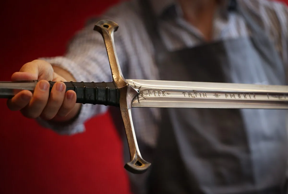 A Bonhams employee holds 'Anduril' a prop sword belonging to Aragorn, hero of 'The Lord of the Rings' movie trilogy in London, England, on July 31, 2014. (Peter Macdiarmid/Getty Images)