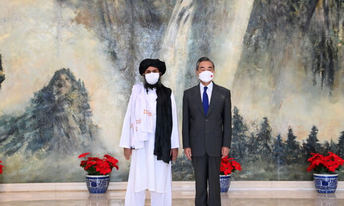 Chinese State Councilor and Foreign Minister Wang Yi meets with Mullah Abdul Ghani Baradar, political chief of Afghanistan's Taliban, in Tianjin, China on July 28, 2021.  (Li Ran/Xinhua via Reuters)