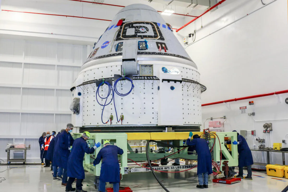 Technicians prepare Boeing's CST-100 Starliner for the company's Orbital Flight Test-2 (OFT-2) in the Commercial Crew and Cargo Processing Facility at NASA's Kennedy Space Center in Florida, on June 2, 2021. (NASA via AP)