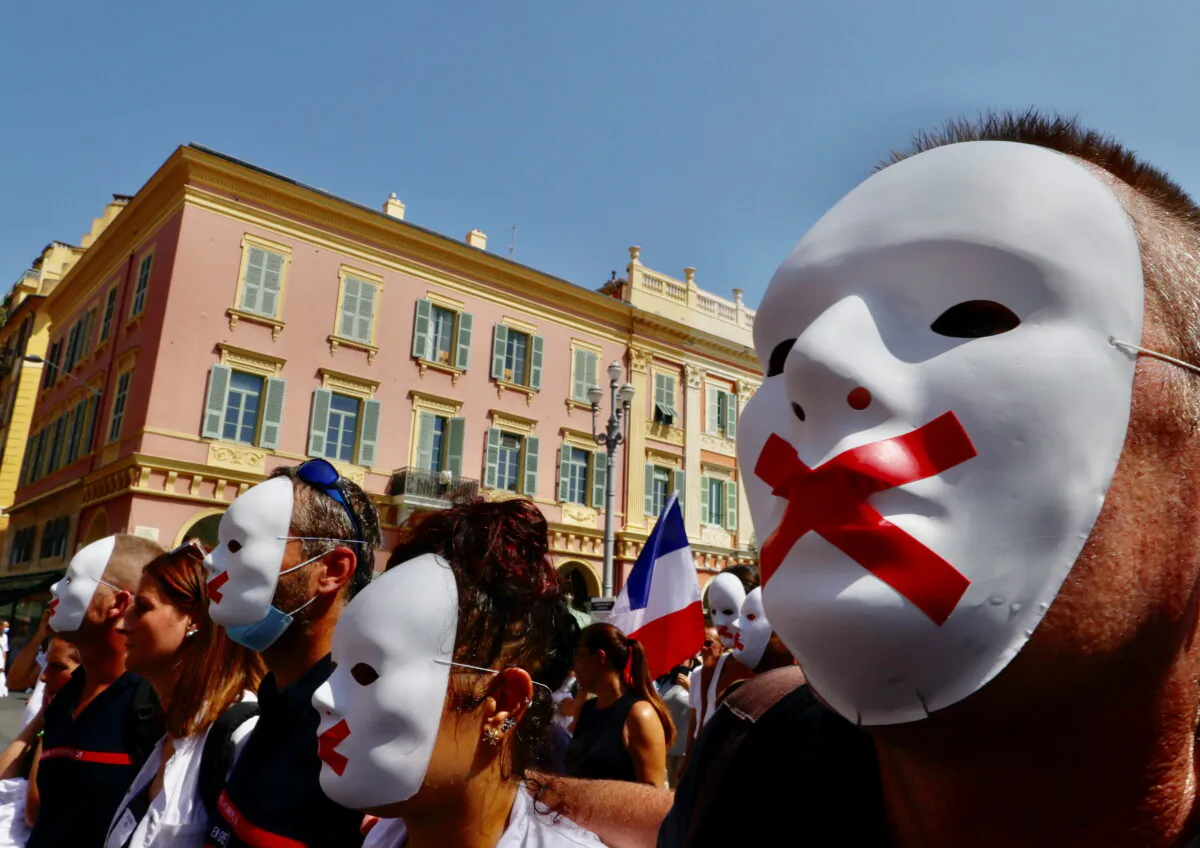 Protesters march against the coronavirus disease (COVID-19) vaccination and the use of health passes to restaurants, bars, trains, and planes in Nice, France, on Aug. 14, 2021. (Eric Gaillard/Reuters)