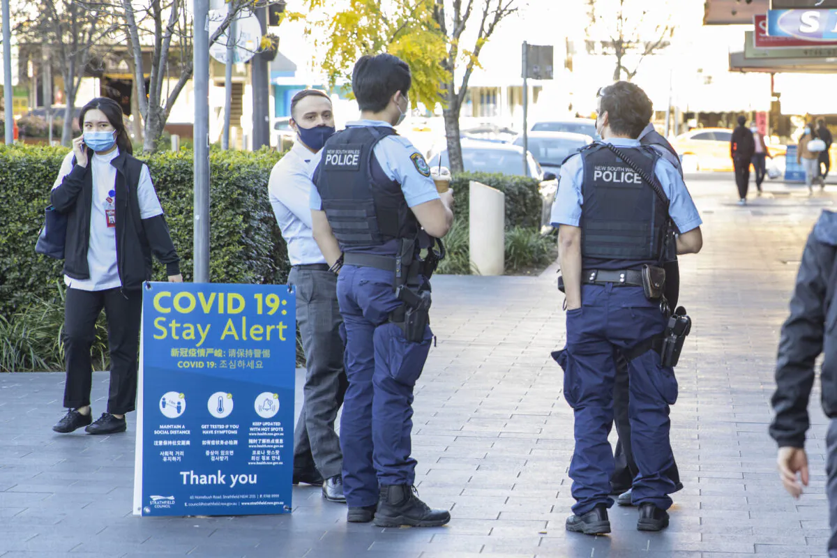 Police officers are seen at Strathfield shopping village  in Sydney, Australia, on Aug. 12, 2021. (Jenny Evans/Getty Images)