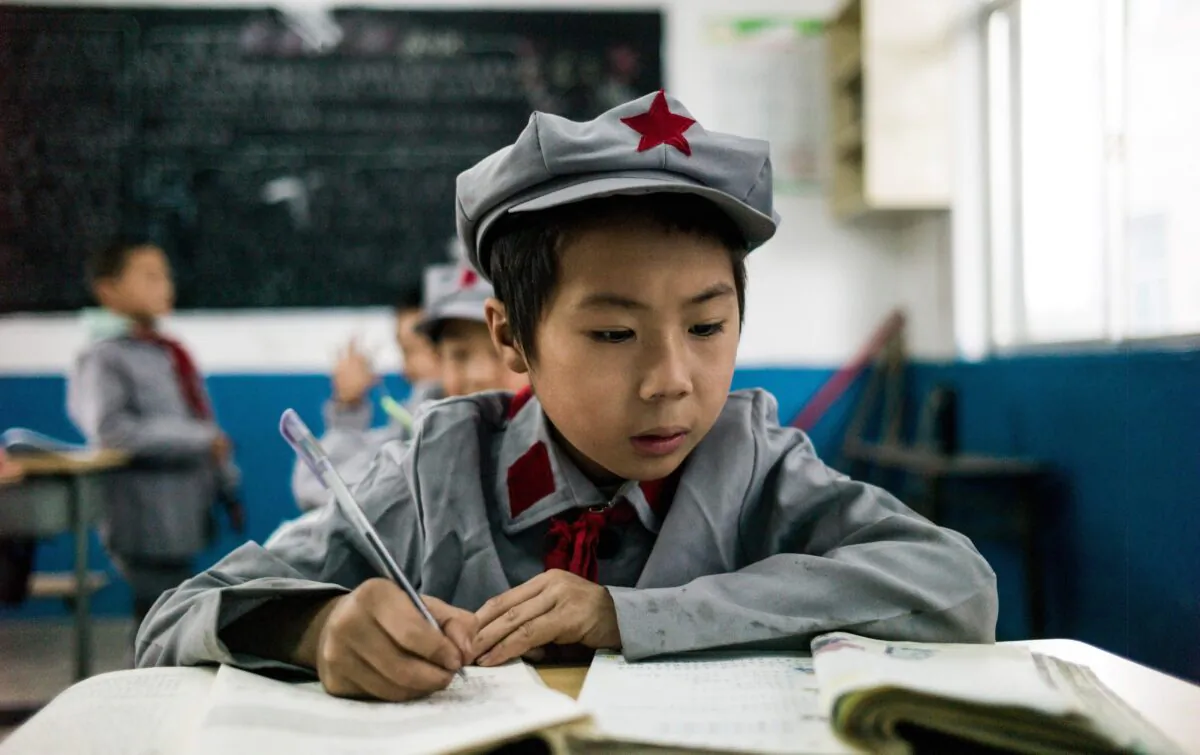 Students study in their classroom at the Yang Dezhi "Red Army" elementary school in Wenshui, Xishui county, Guizhou Province, on Nov. 7, 2016. (Fred Dufour/AFP via Getty Images)
