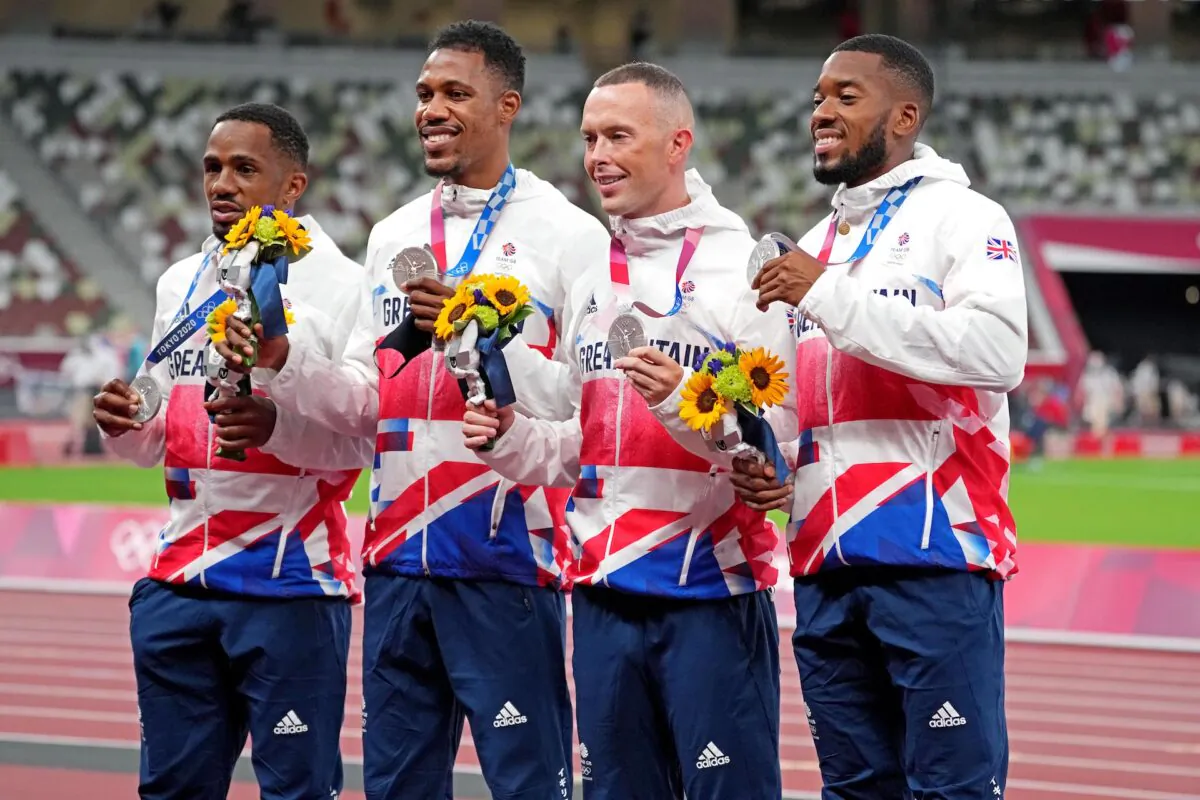 (L–R) Chijindu Ujah, Zharnel Hughes, Richard Kilty and Nethaneel Mitchell-Blake celebrate winning the silver medal in the men's 4x100 relay during the Tokyo 2020 Olympic Summer Games at the Olympic Stadium in Tokyo, Japan, on Aug 7, 2021. (Kirby Lee/USA TODAY Sports)