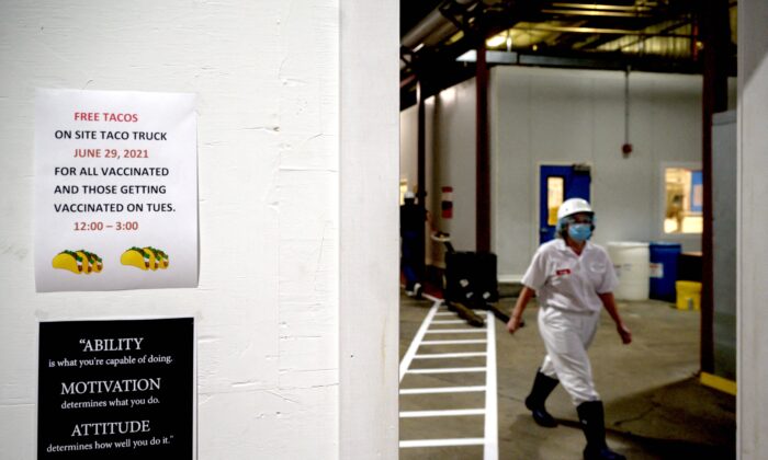 A sign encouraging employees to get vaccinated against COVID-19 is displayed at the Vermont Creamery in Websterville, Vt., on June 29, 2021. (ED JONES/AFP via Getty Images)
