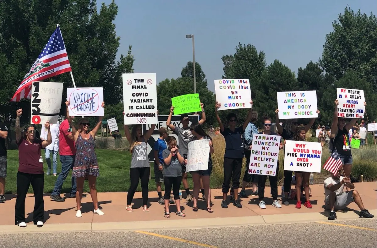 A number of people gather outside UCHealth of the Rockies to protest the health care system's decision to terminate employees who refuse the vaccine in Loveland, Colo., on Aug. 13, 2021. (Allan Stein/The Epoch Times)