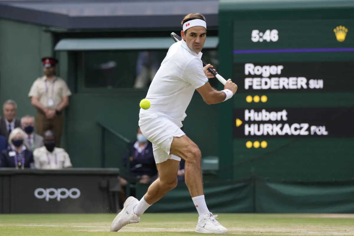 Switzerland's Roger Federer plays a return to Poland's Hubert Hurkacz during the men's singles quarterfinals match on the ninth day of the Wimbledon Tennis Championships in London, on July 7, 2021. (Kirsty Wigglesworth/AP Photo)