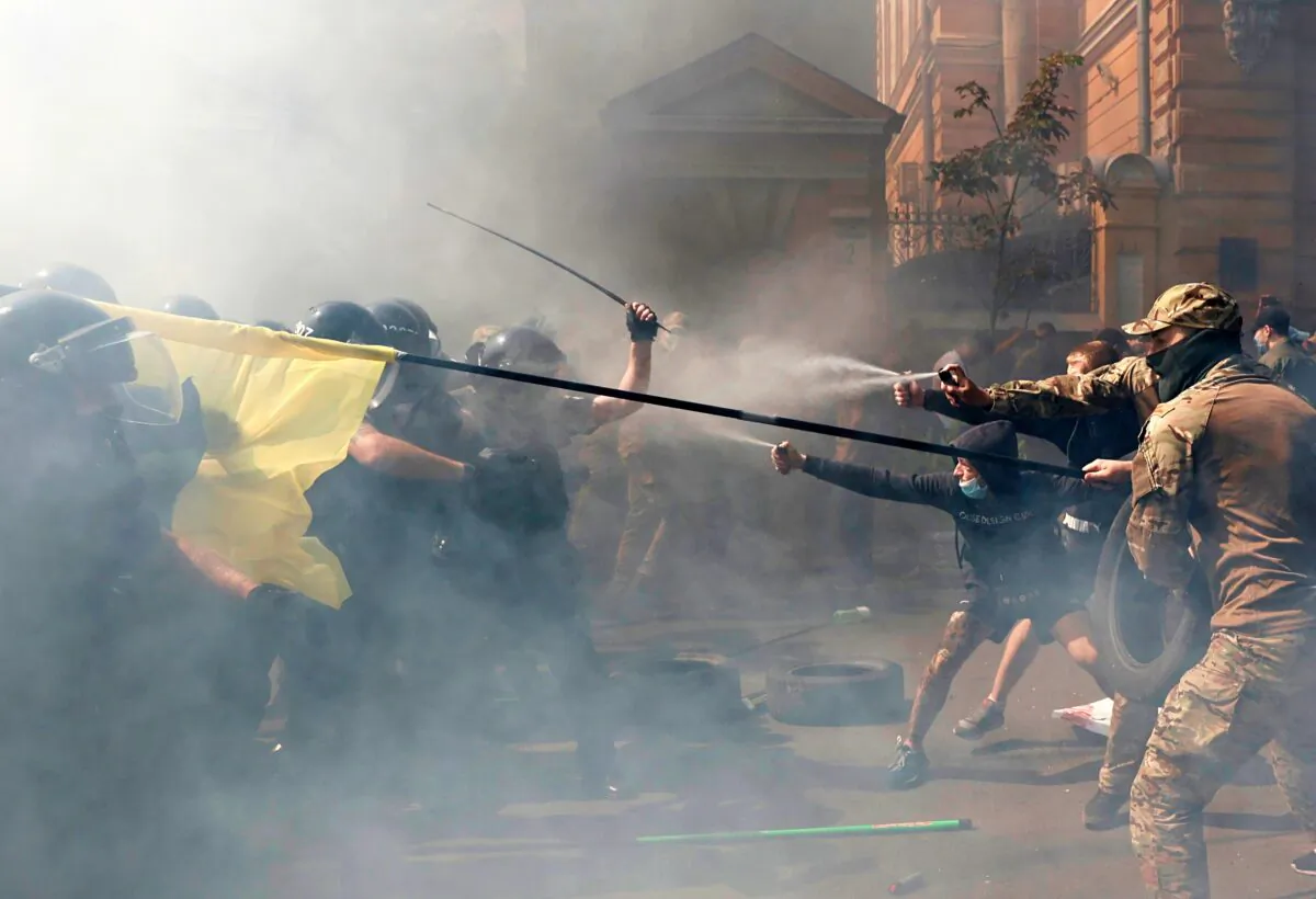 Demonstrators clash with police officers during a protest by activists of the National Corps political party in front of the presidential office building in Kyiv, Ukraine, on Aug. 14, 2021. (Serhii Nuzhnenko/Reuters)