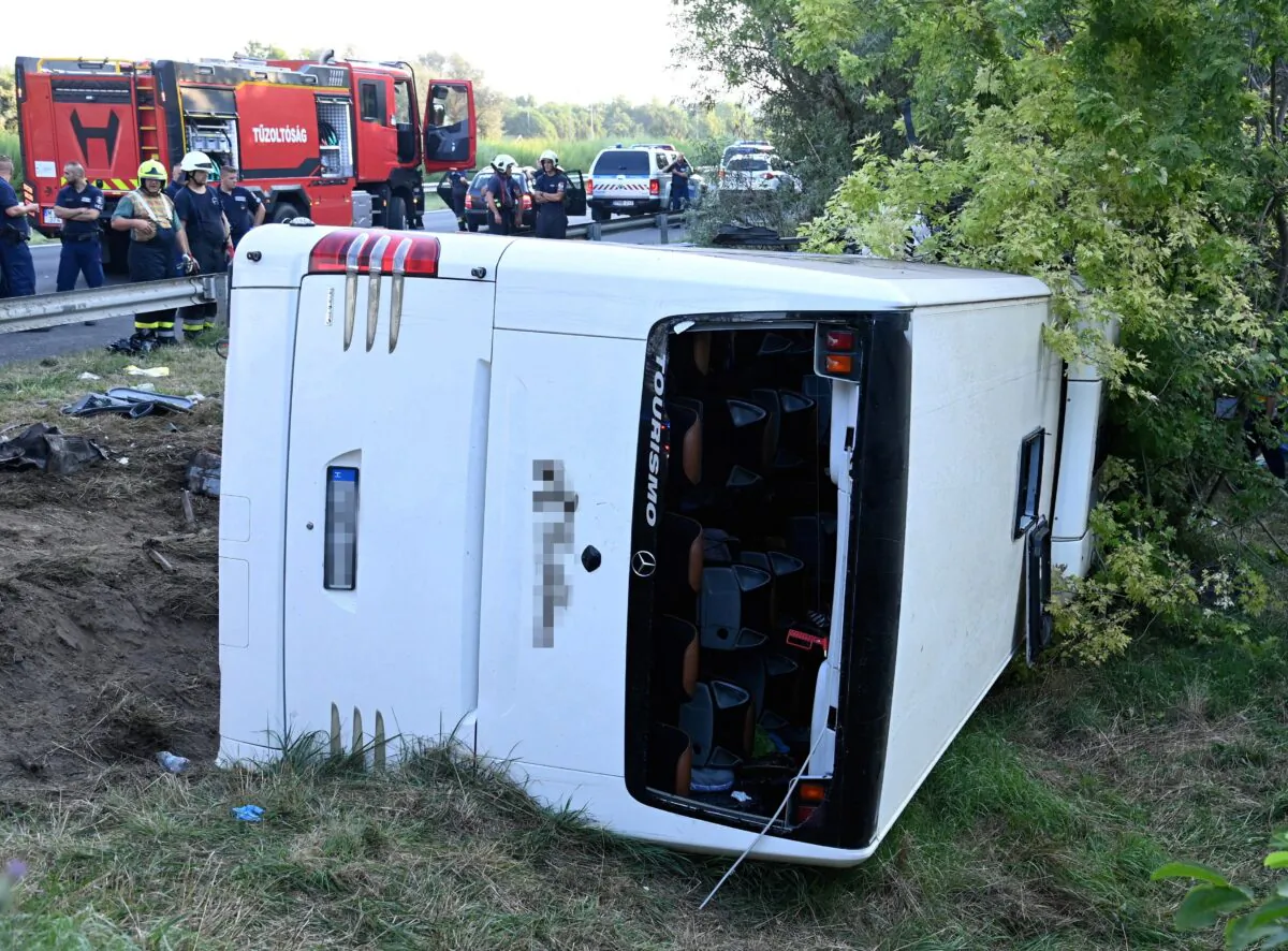 View of the bus that rolled over on the M7 motorway, killing at least eight people, in the early hours of Sunday near Szabadbattyan, Hungary, on Aug. 15, 2021. (Zoltan Mihadak/Pool via Reuters)