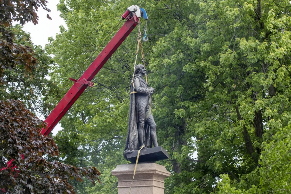 The statue of Sir John A. Macdonald is removed from a park in his hometown of Kingston, Ont., on June 18, 2021. (The Canadian Press/Lars Hagberg)