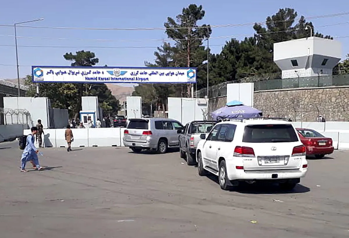 Afghan police check the cars at the entrance gate of Hamid Karzai International Airport in Kabul, Afghanistan, on Aug. 15, 2021. (Stringer/Reuters)