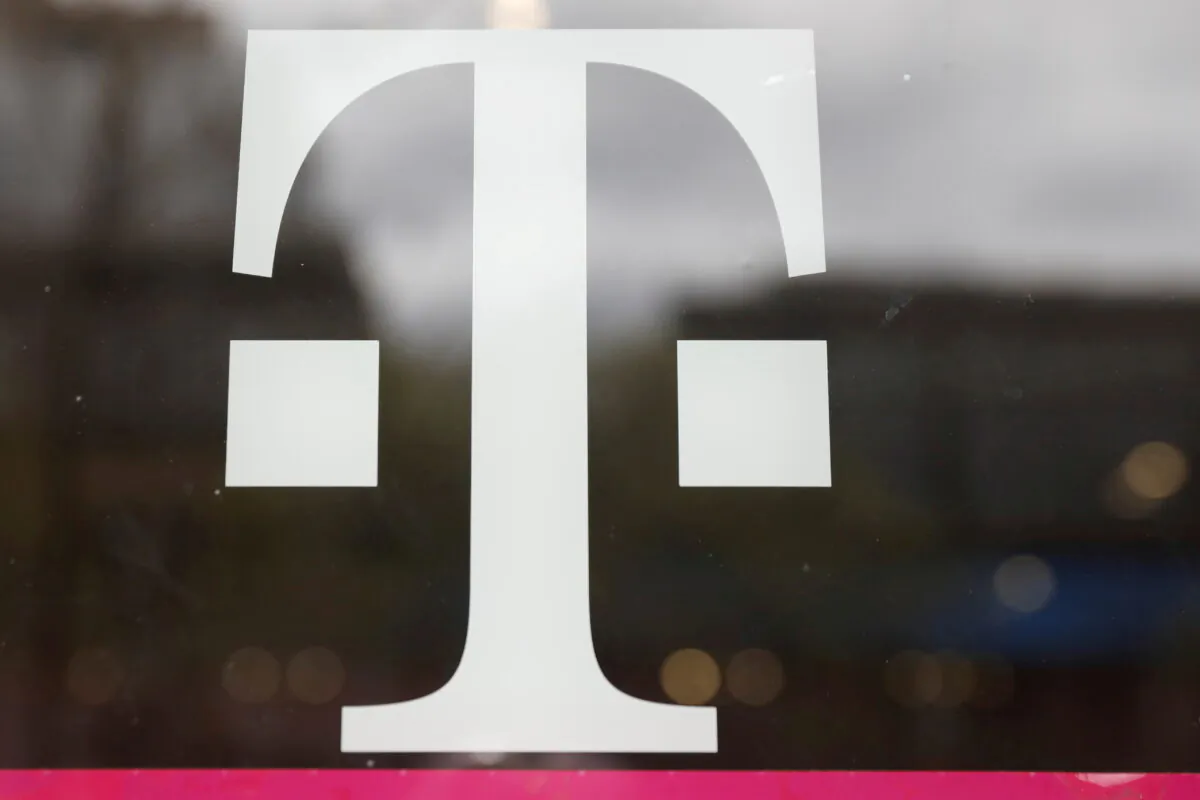 A T-Mobile logo is seen on the storefront door of a store in Manhattan, New York City, on April 30, 2018. (Shannon Stapleton/Reuters)