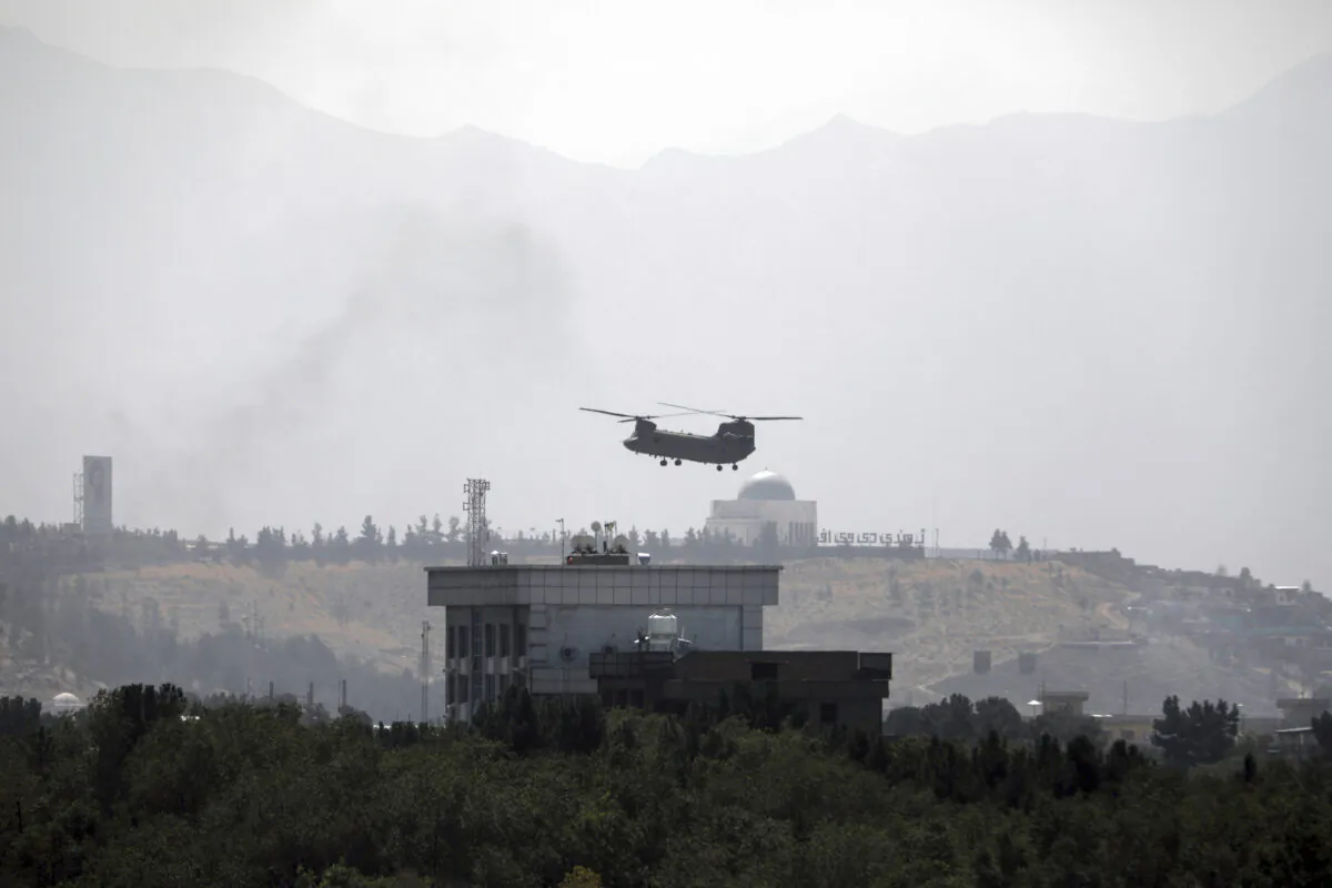 A U.S. Chinook helicopter flies over the U.S. Embassy, in Kabul, Afghanistan, on Aug. 15, 2021. (Rahmat Gul/AP Photo)