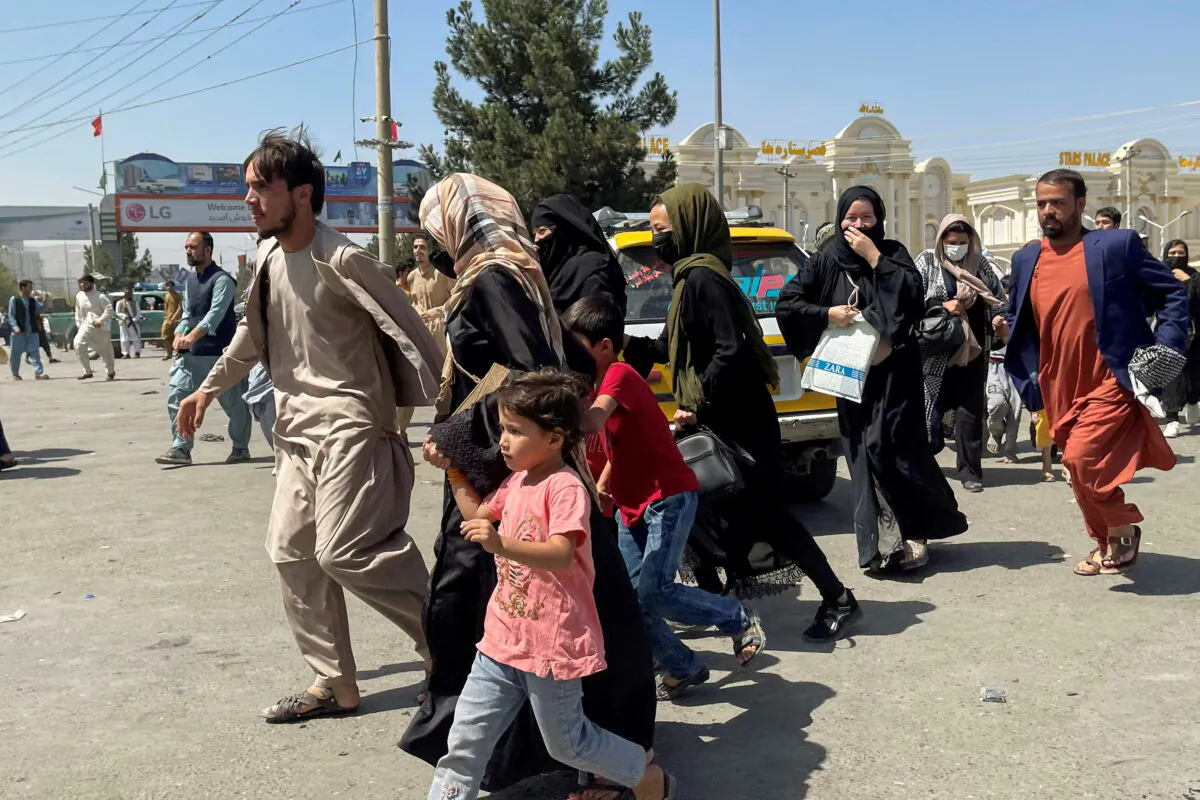 People try to get into Hamid Karzai International Airport in Kabul, Afghanistan Aug. 16, 2021. (Reuters/Stringer)