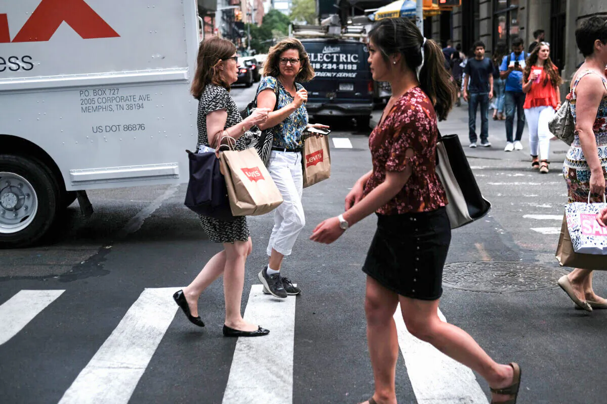 People walk along a shopping street in lower Manhattan in New York City on July 5, 2019. (Spencer Platt/Getty Images)