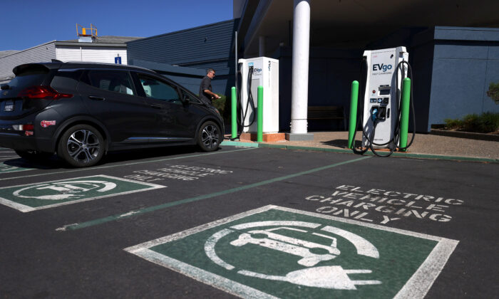 An electric car owner prepares to charge his car at an electric car charging station in Corte Madera, Calif., on Sept. 23, 2020. (Justin Sullivan/Getty Images)