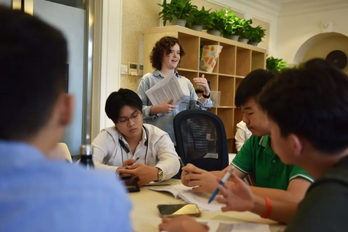 College counsellor speaks with students during a class at Elite Scholars China, a boutique college consultancy where students can receive application guidance, mentoring, and advice on the best courses for their interests and skills, in Beijing, China on July 19, 2019. (Greg Baker/AFP via Getty Images)