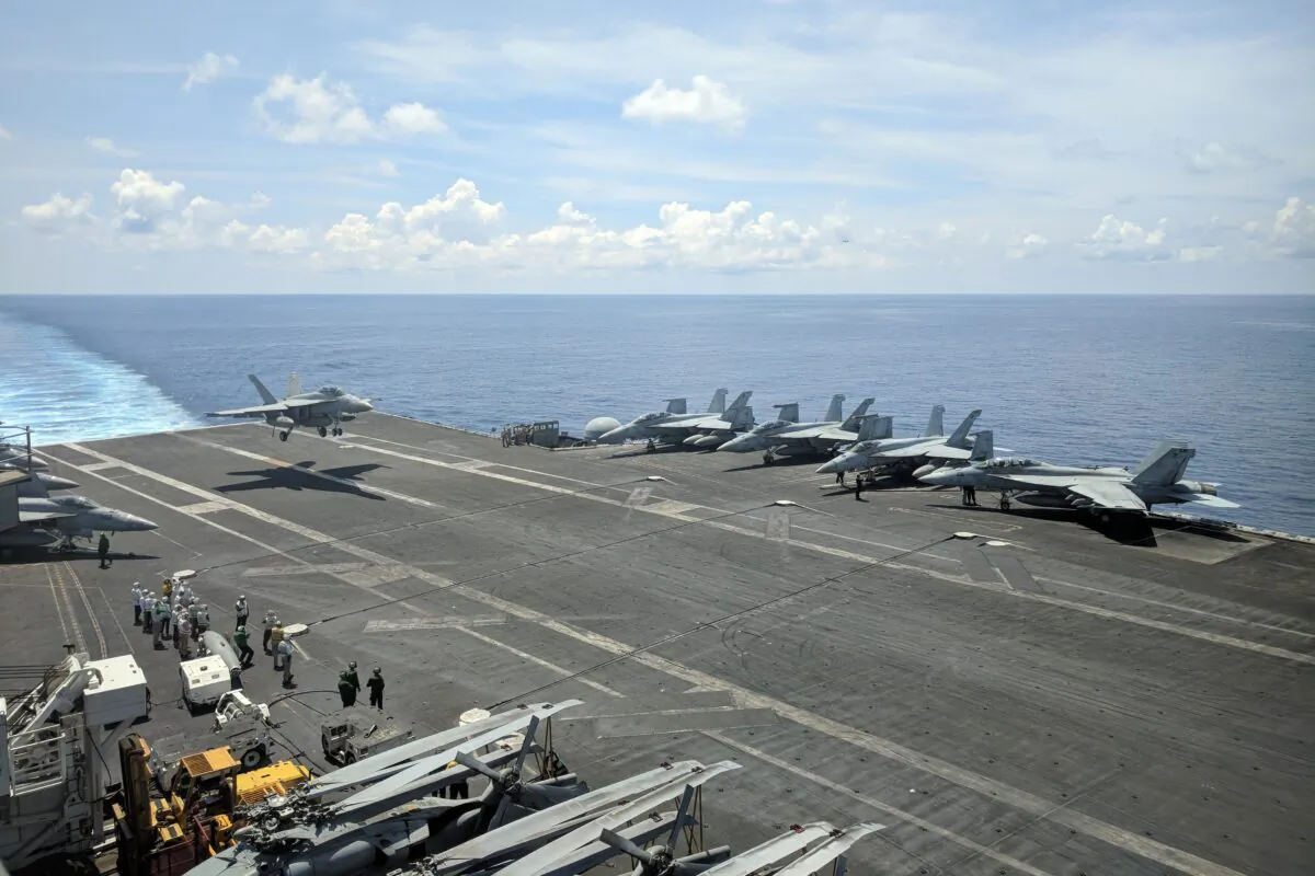 This photograph taken on October 16, 2019 shows a US Navy F/A-18 Super Hornets multirole fighter landing on the flight deck of USS Ronald Reagan (CVN-76) aircraft carrier as it sails in South China Sea on its way to Singapore. (Photo by Catherine LAI / AFP) (Photo by CATHERINE LAI/AFP via Getty Images)