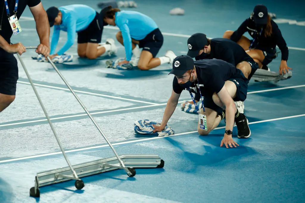 Volunteers dry the court during semi-final singles match on day five of the 2021 ATP Cup at Rod Laver Arena, in Melbourne, Australia, on Feb. 06, 2021 (Daniel Pockett/Getty Images)