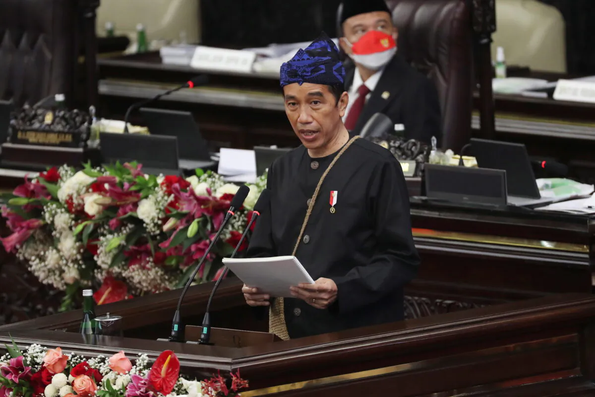 Indonesian President Joko Widodo, wearing traditional Baduy outfit, delivers his annual State of the Nation Address ahead of the country's Independence Day, at the parliament building in Jakarta, Indonesia, on Aug. 16, 2021. (Achmad Ibrahim/Pool via Reuters)