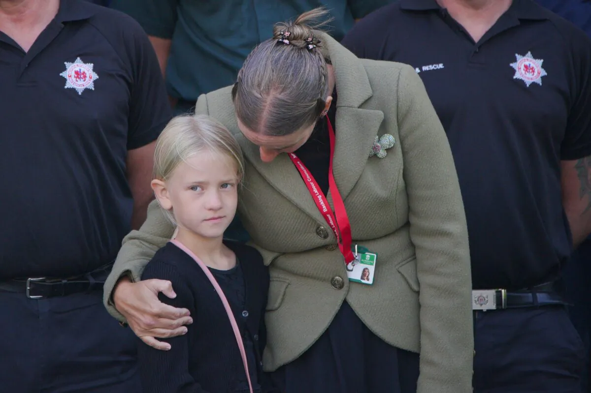 People take part in a minute's silence outside Plymouth Guildhall in memory of the five people that were killed by gunman Jake Davison in a firearms incident in Plymouth, United Kingdom, on Aug. 16, 2021. (Ben Birchall/PA)