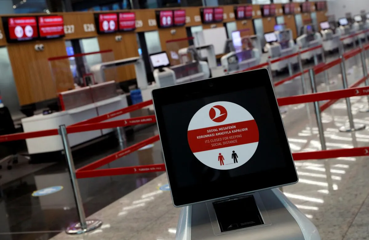 A social distancing sign is seen before check-in counters in Turkey, on June 19, 2020. (Murad Sezer/Reuters)