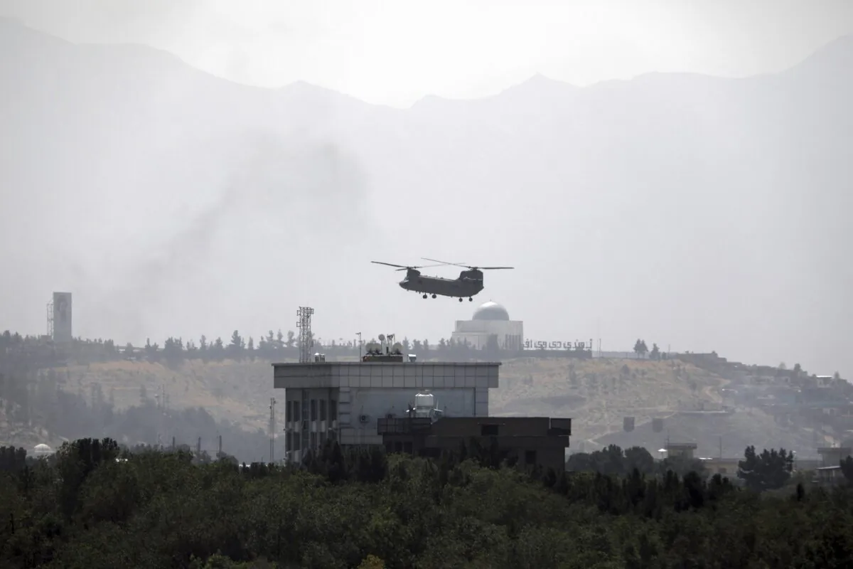 A U.S. Chinook helicopter flies over the U.S. Embassy in Kabul, Afghanistan, on Aug. 15, 2021. (Rahmat Gul/AP Photo)