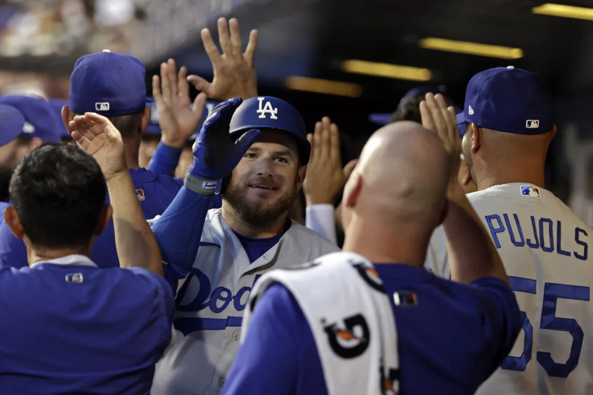 Los Angeles Dodgers' Max Muncy celebrates a two-run home run in the dugout during the second inning of a baseball game against the New York Mets in New York on Aug. 15, 2021. (AP Photo/Adam Hunger)