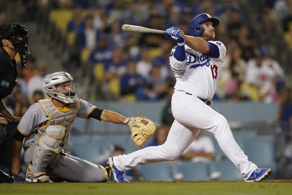 Los Angeles Dodgers' Max Muncy follows through on his solo home run during the eighth inning of a baseball game against the Pittsburgh Pirates in Los Angeles on Aug. 16, 2021. (AP Photo/Marcio Jose Sanchez)