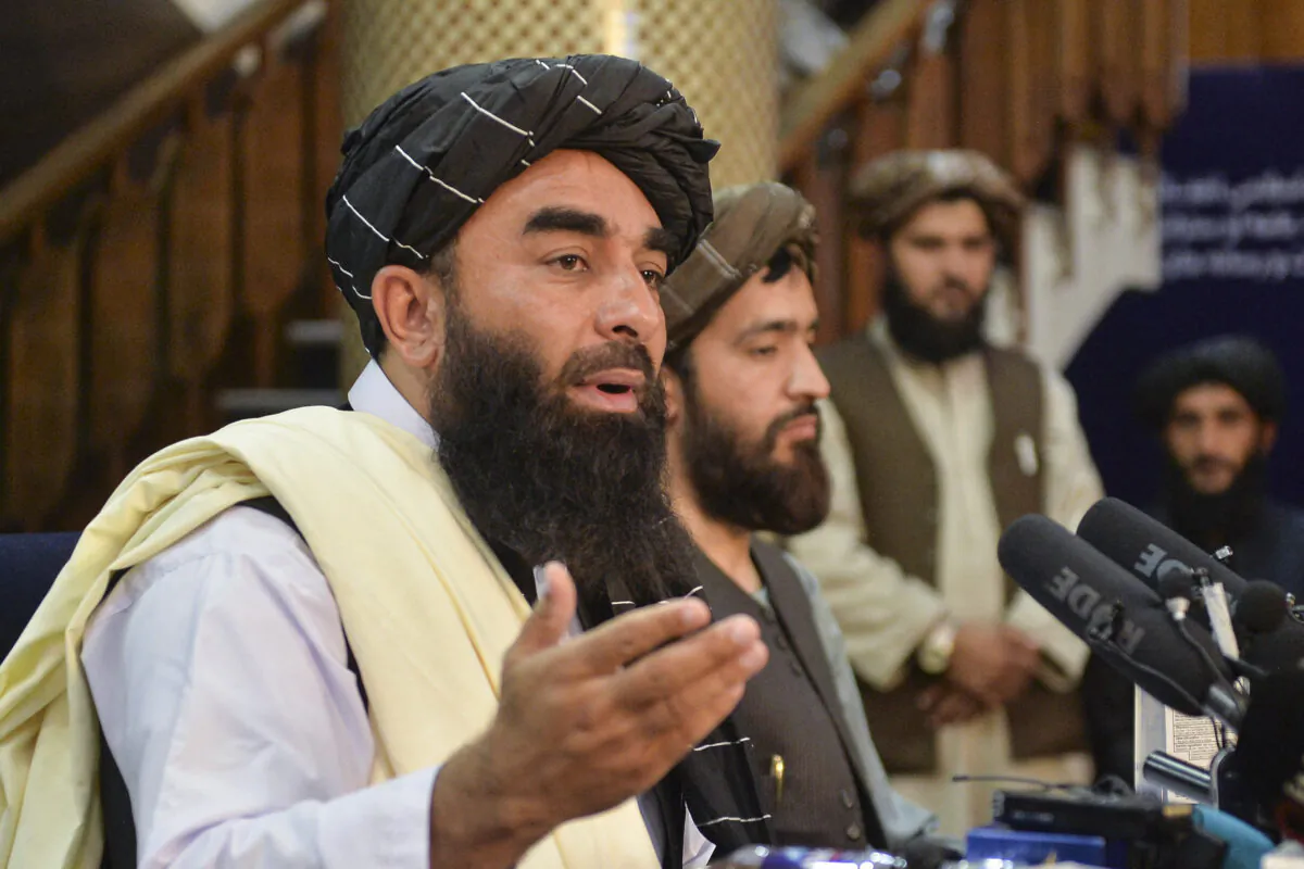 Taliban spokesperson Zabihullah Mujahid (L) gestures as he speaks during the first press conference in Kabul, Afghanistan, on Aug. 17, 2021. The Taliban Wants Stronger China Relations as it is back in power in Afghanistan. (Hoshang Hashimi /AFP via Getty Images) 